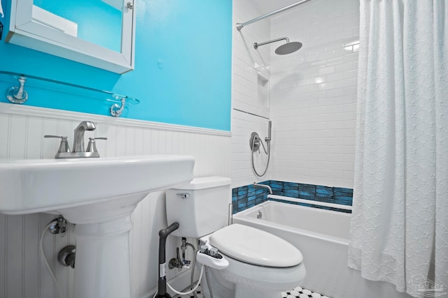 full bathroom with sink, toilet, and shower / bath combination with curtain