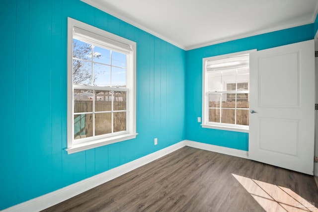 spare room featuring ornamental molding and hardwood / wood-style flooring