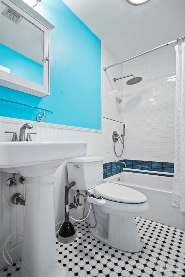 full bathroom with toilet, tile patterned flooring, sink, and shower / bathtub combination with curtain