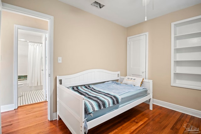 bedroom featuring wood-type flooring and connected bathroom