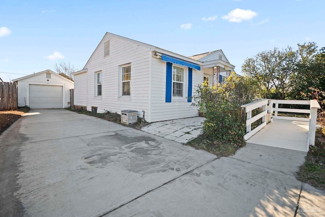 view of front of property featuring a garage and an outbuilding