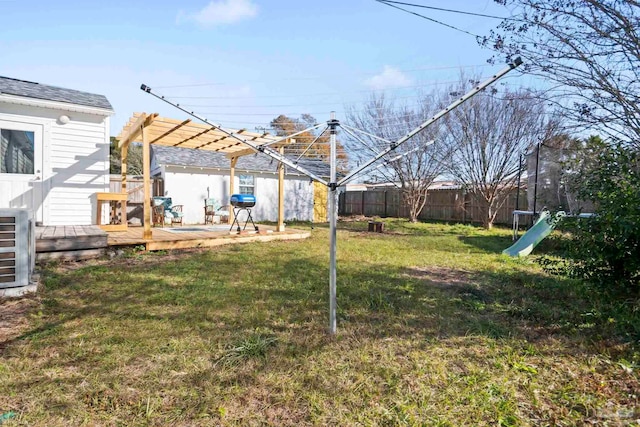 view of yard featuring a trampoline, a pergola, and a deck