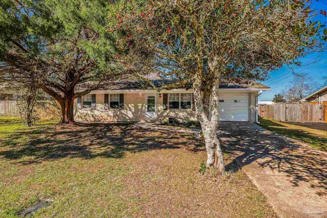 view of front of house with brick siding, an attached garage, fence, driveway, and a front lawn