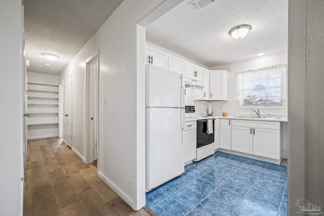 kitchen featuring white appliances, visible vents, light countertops, under cabinet range hood, and white cabinetry