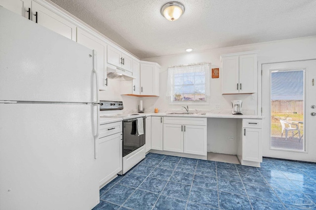 kitchen with white appliances, white cabinets, light countertops, under cabinet range hood, and a sink