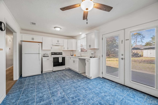 kitchen featuring under cabinet range hood, white appliances, visible vents, white cabinets, and light countertops