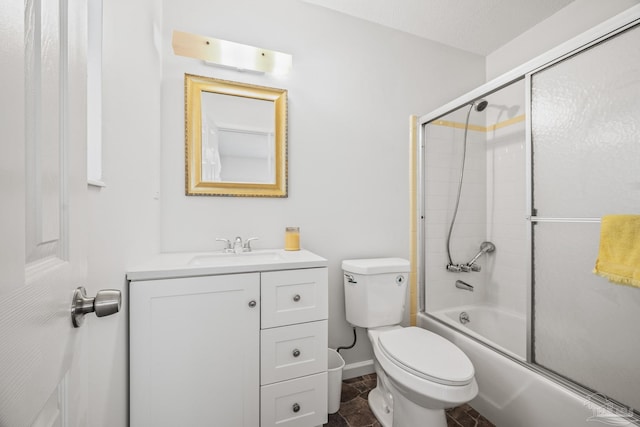 bathroom featuring toilet, enclosed tub / shower combo, baseboards, and vanity