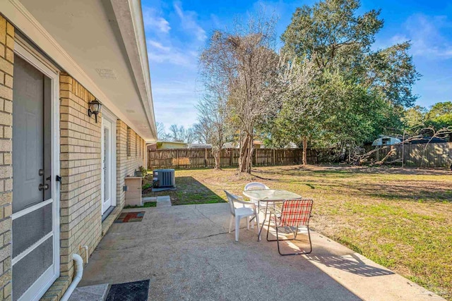 view of patio / terrace featuring outdoor dining area, a fenced backyard, and central AC unit