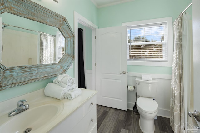 full bath with wood finished floors, vanity, toilet, crown molding, and a shower with curtain