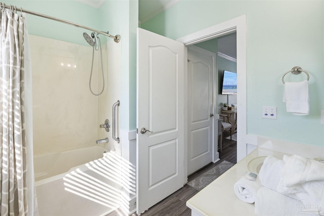 full bath featuring ornamental molding, shower / bath combo with shower curtain, and wood finished floors