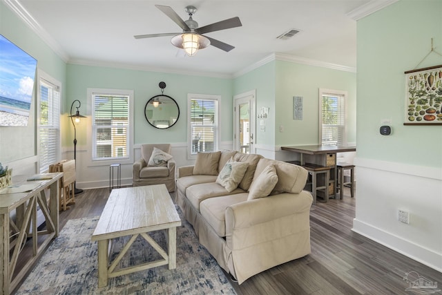living room featuring dark wood finished floors, a ceiling fan, healthy amount of natural light, ornamental molding, and baseboards