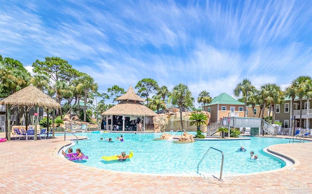 community pool featuring a gazebo, stairs, fence, and a patio area