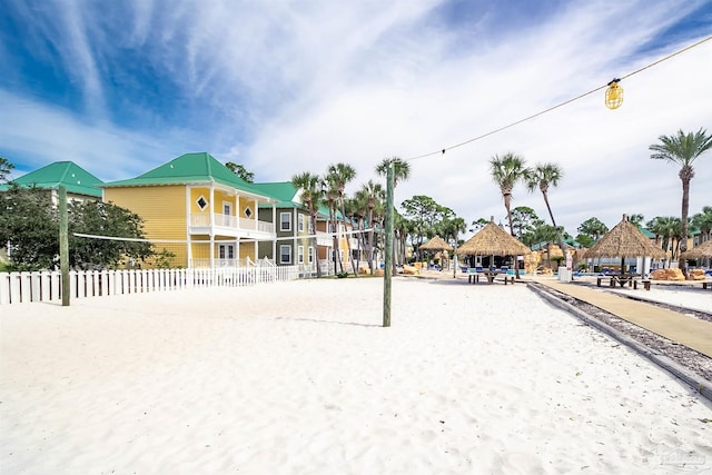 view of home's community featuring a gazebo, volleyball court, and fence