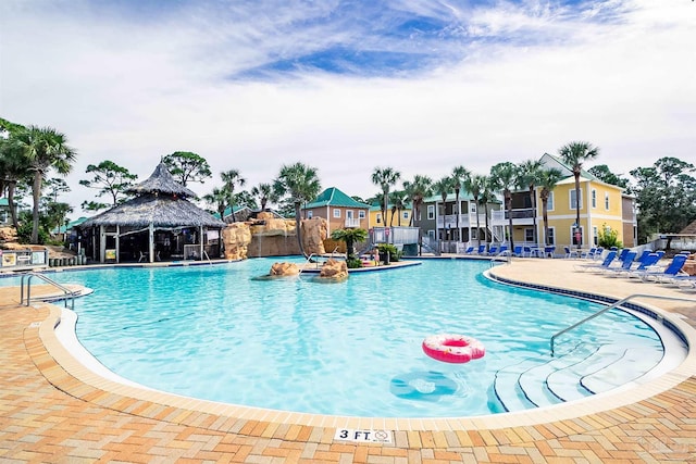 community pool featuring a gazebo, a patio area, and fence