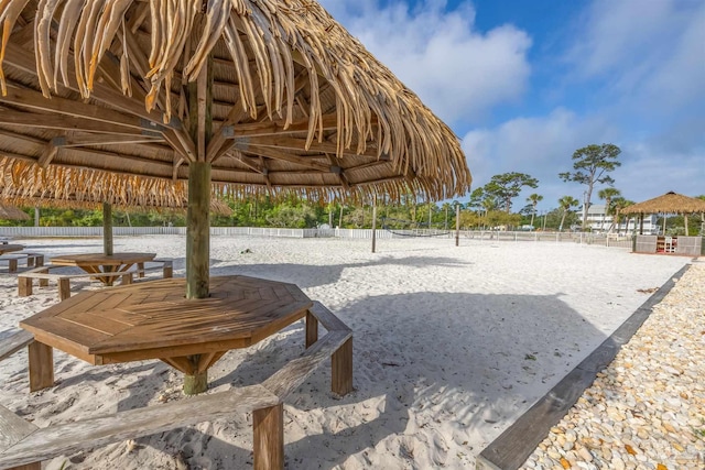 view of community featuring a gazebo, volleyball court, and fence