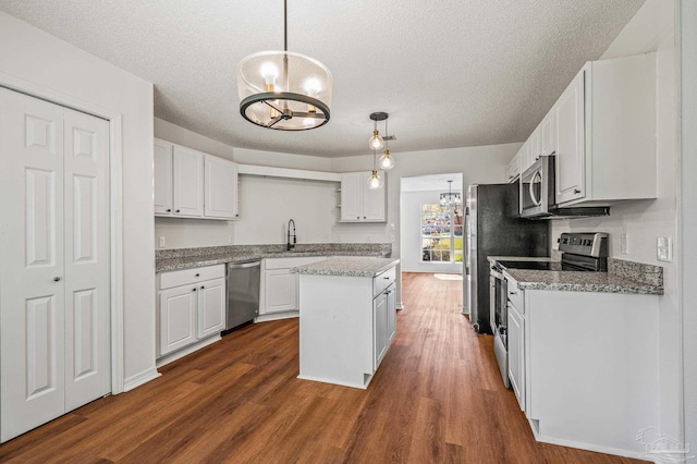 kitchen featuring white cabinetry, an inviting chandelier, and appliances with stainless steel finishes