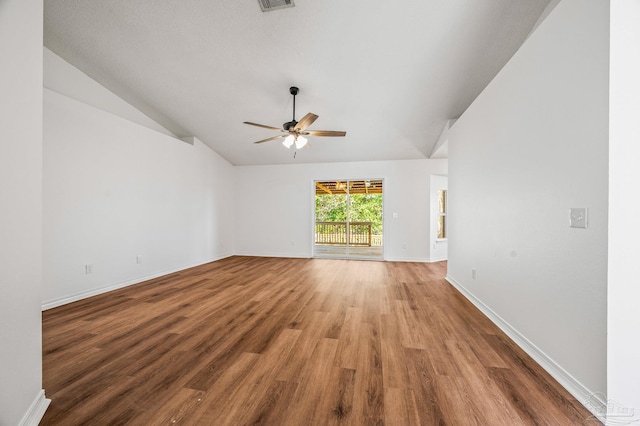 spare room with baseboards, light wood-style floors, a ceiling fan, and vaulted ceiling