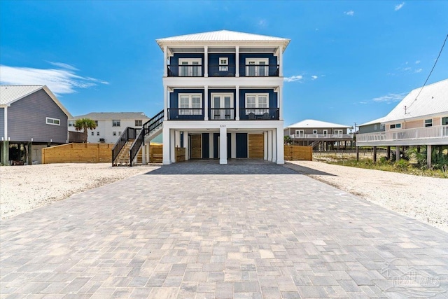 8169 White Sands Blvd, Navarre Beach, FL 32566 - beach home featuring a balcony, decorative driveway, and stairs