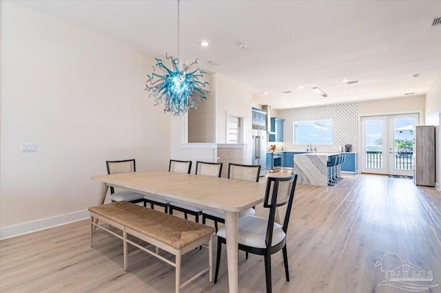8169 White Sands Blvd, Navarre Beach, FL 32566 - dining space featuring french doors, light wood-type flooring, baseboards, and recessed lighting