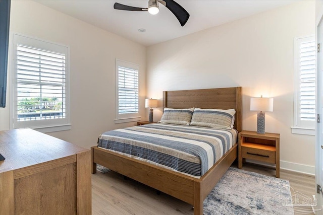 8169 White Sands Blvd, Navarre Beach, FL 32566 - bedroom featuring wood finished floors, multiple windows, and ceiling fan