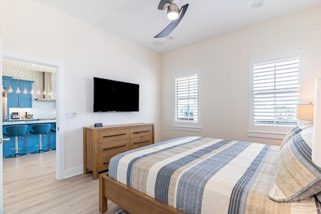 8169 White Sands Blvd, Navarre Beach, FL 32566 - bedroom featuring light wood-type flooring, a ceiling fan, and baseboards