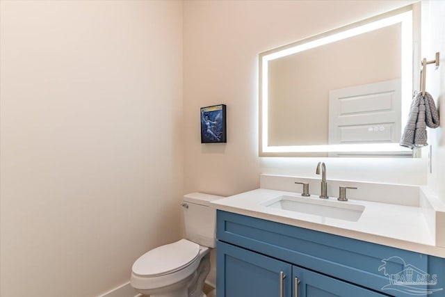 8169 White Sands Blvd, Navarre Beach, FL 32566 - half bathroom featuring toilet, vanity, and baseboards