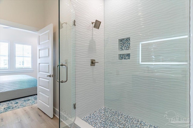 8169 White Sands Blvd, Navarre Beach, FL 32566 - ensuite bathroom with a shower stall and wood finished floors