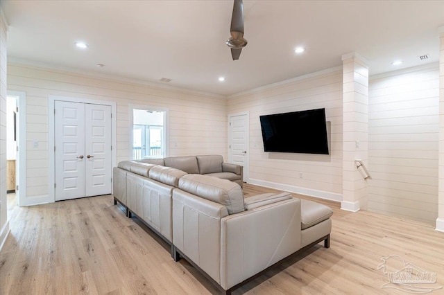 8169 White Sands Blvd, Navarre Beach, FL 32566 - living room featuring light wood finished floors, ornamental molding, wood walls, and recessed lighting