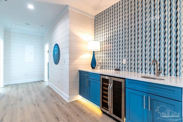 8169 White Sands Blvd, Navarre Beach, FL 32566 - indoor wet bar featuring wine cooler, light wood-style floors, baseboards, and wooden walls