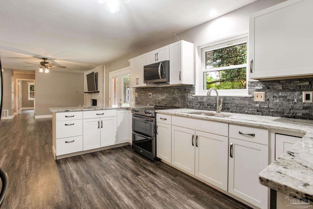 8818 Klondike Rd, Pensacola, FL 32526 - kitchen with stainless steel appliances, a peninsula, tasteful backsplash, and dark wood-type flooring