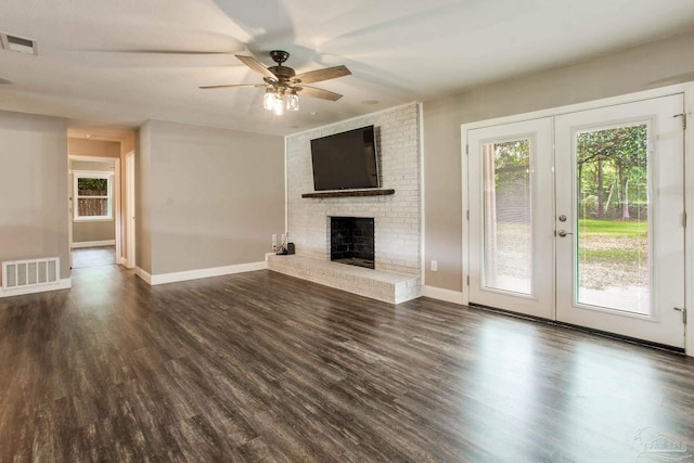 8818 Klondike Rd, Pensacola, FL 32526 - unfurnished living room with ceiling fan, healthy amount of natural light, a fireplace, and dark wood-type flooring