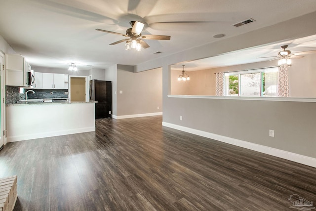 8818 Klondike Rd, Pensacola, FL 32526 - unfurnished living room with a ceiling fan, dark wood-style flooring, and a chandelier