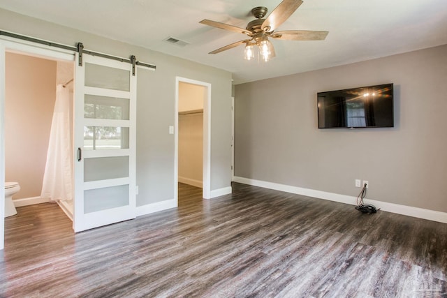 8818 Klondike Rd, Pensacola, FL 32526 - unfurnished living room featuring a barn door, wood finished floors, and ceiling fan