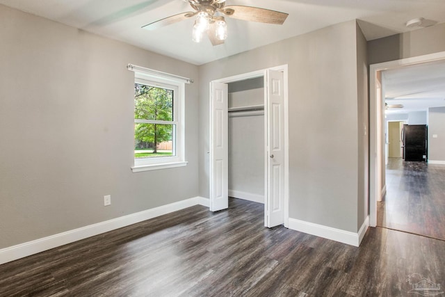 8818 Klondike Rd, Pensacola, FL 32526 - unfurnished bedroom featuring freestanding refrigerator, dark wood finished floors, a closet, and ceiling fan
