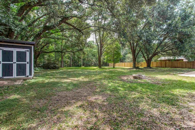 8818 Klondike Rd, Pensacola, FL 32526 - view of yard with a fire pit and a storage shed