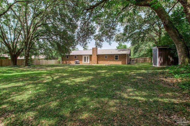 8818 Klondike Rd, Pensacola, FL 32526 - fenced backyard featuring a storage unit