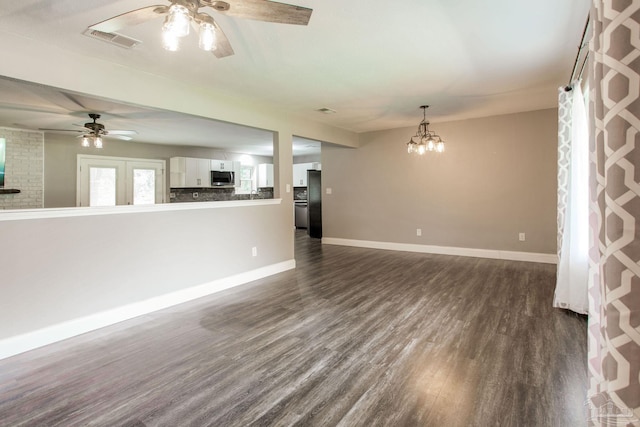 8818 Klondike Rd, Pensacola, FL 32526 - unfurnished living room featuring ceiling fan, dark wood finished floors, and a chandelier