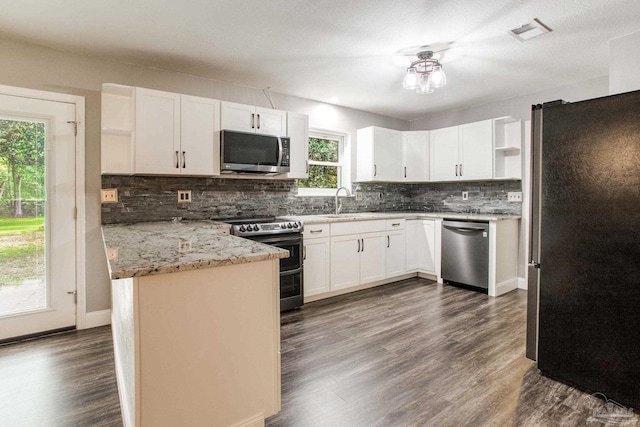 8818 Klondike Rd, Pensacola, FL 32526 - kitchen with appliances with stainless steel finishes, open shelves, decorative backsplash, a peninsula, and white cabinets