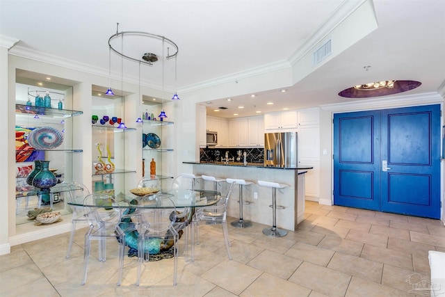 interior space with crown molding and light tile patterned floors