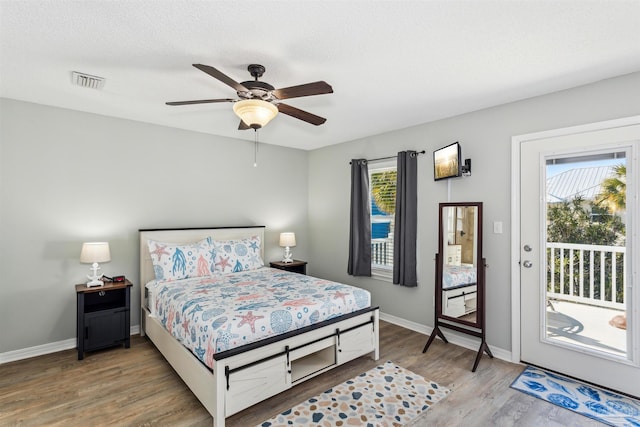 bedroom with hardwood / wood-style flooring, ceiling fan, and access to exterior