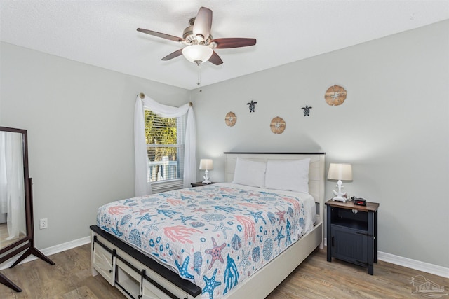 bedroom featuring wood-type flooring and ceiling fan