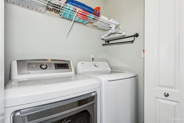 clothes washing area featuring washer and dryer