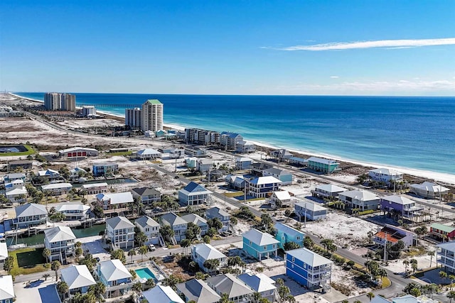 bird's eye view featuring a water view and a beach view