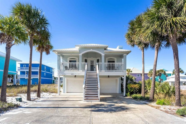 view of front of house with a porch and a garage