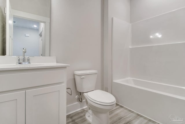 9797 Windyhill Rd, Pensacola, FL 32526 - full bath with toilet, wood finished floors, vanity, and shower / bathtub combination