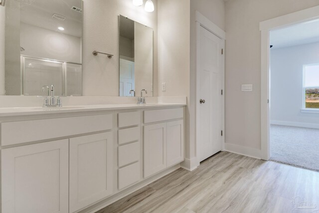 9797 Windyhill Rd, Pensacola, FL 32526 - full bathroom with a stall shower, wood finished floors, double vanity, and baseboards