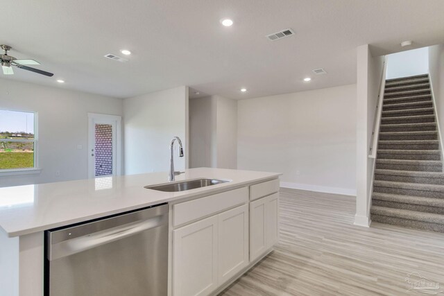 9797 Windyhill Rd, Pensacola, FL 32526 - kitchen with stainless steel dishwasher, a sink, white cabinets, ceiling fan, and light wood-style flooring
