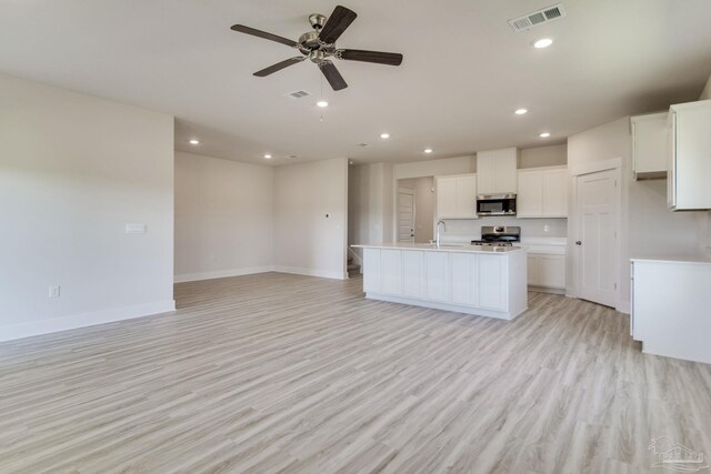 9797 Windyhill Rd, Pensacola, FL 32526 - kitchen featuring stainless steel appliances, a sink, open floor plan, recessed lighting, and light wood finished floors