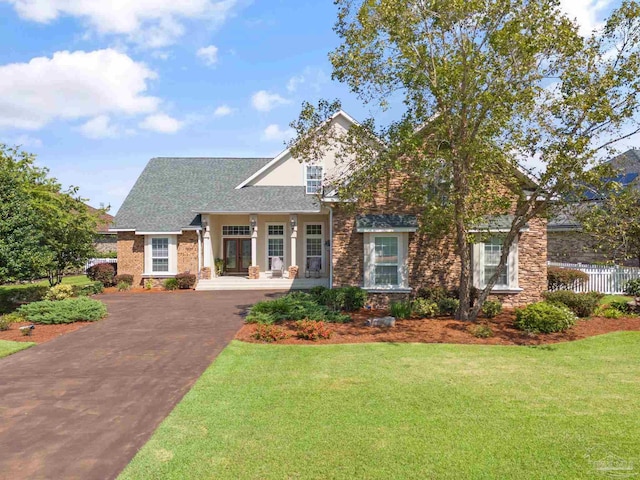 view of front of home with covered porch and a front yard