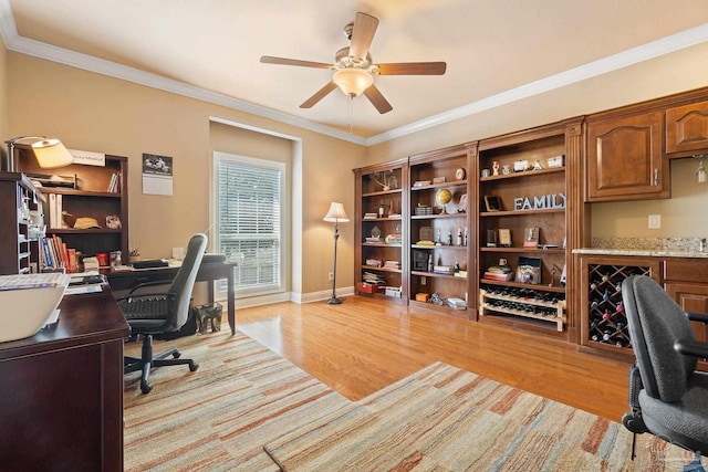 home office with light hardwood / wood-style flooring, ceiling fan, and ornamental molding